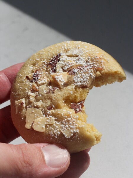 Close up shot of almond cookie with a bite in it