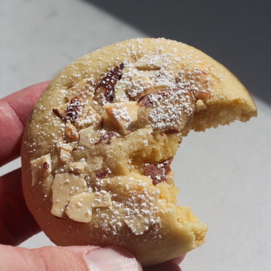 Close up shot of almond cookie with a bite in it