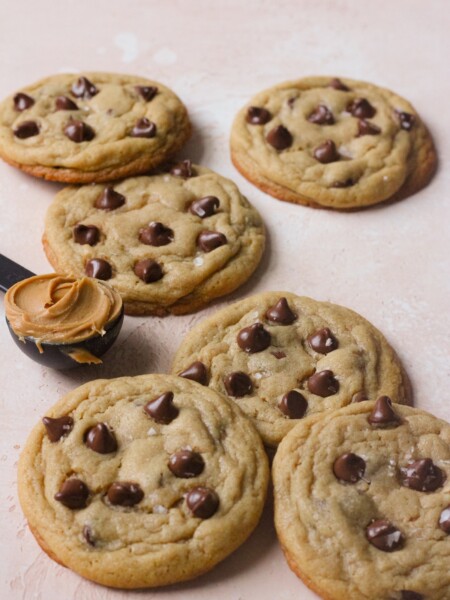 Peanut butter chocolate chip cookies on a pink backdrop
