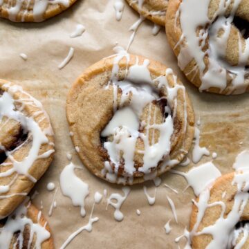 Cinnamon roll cookies on a baking sheet covered with parchment paper.