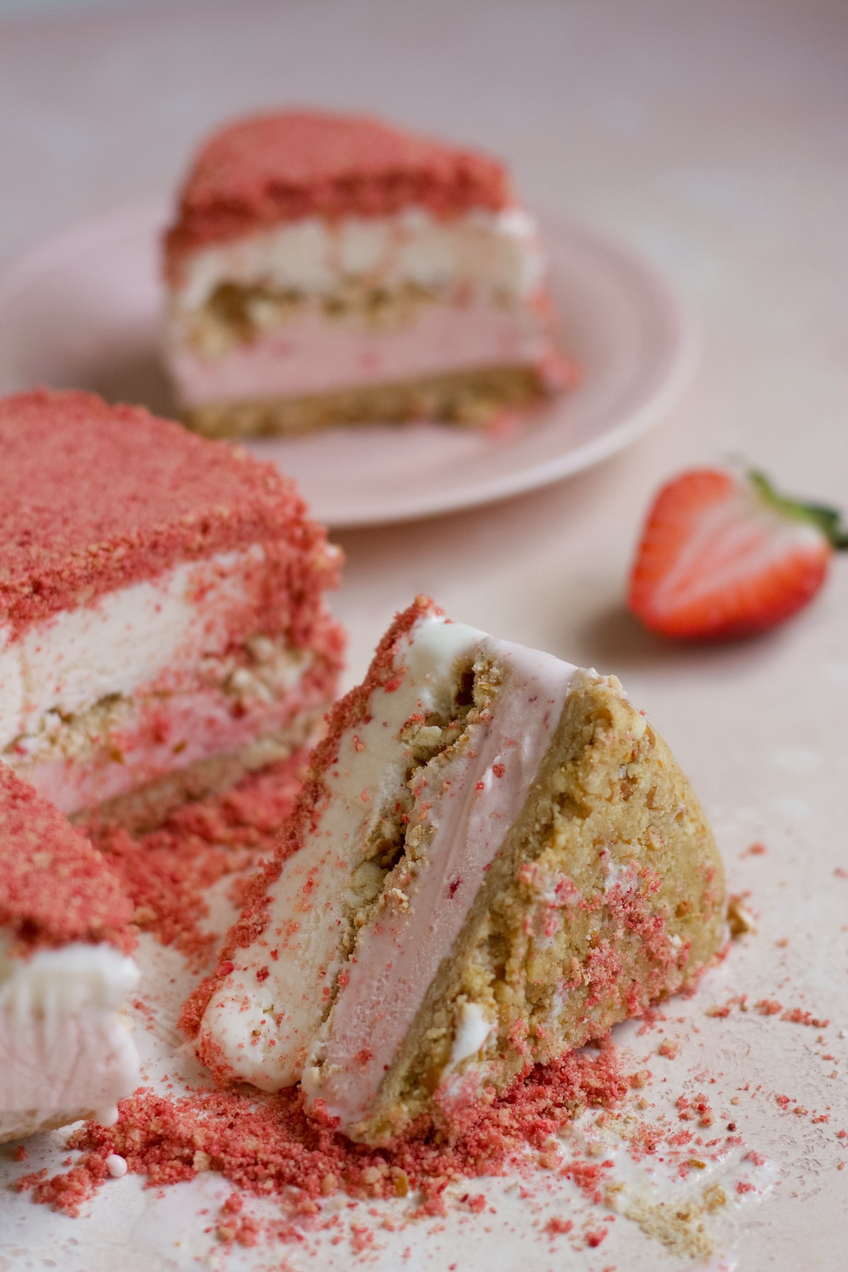 Strawberry crunch ice cream cake on a pink backdrop