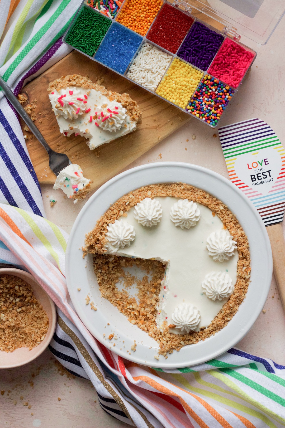 Confetti ice cream pie close up shot with a slice on a cutting board