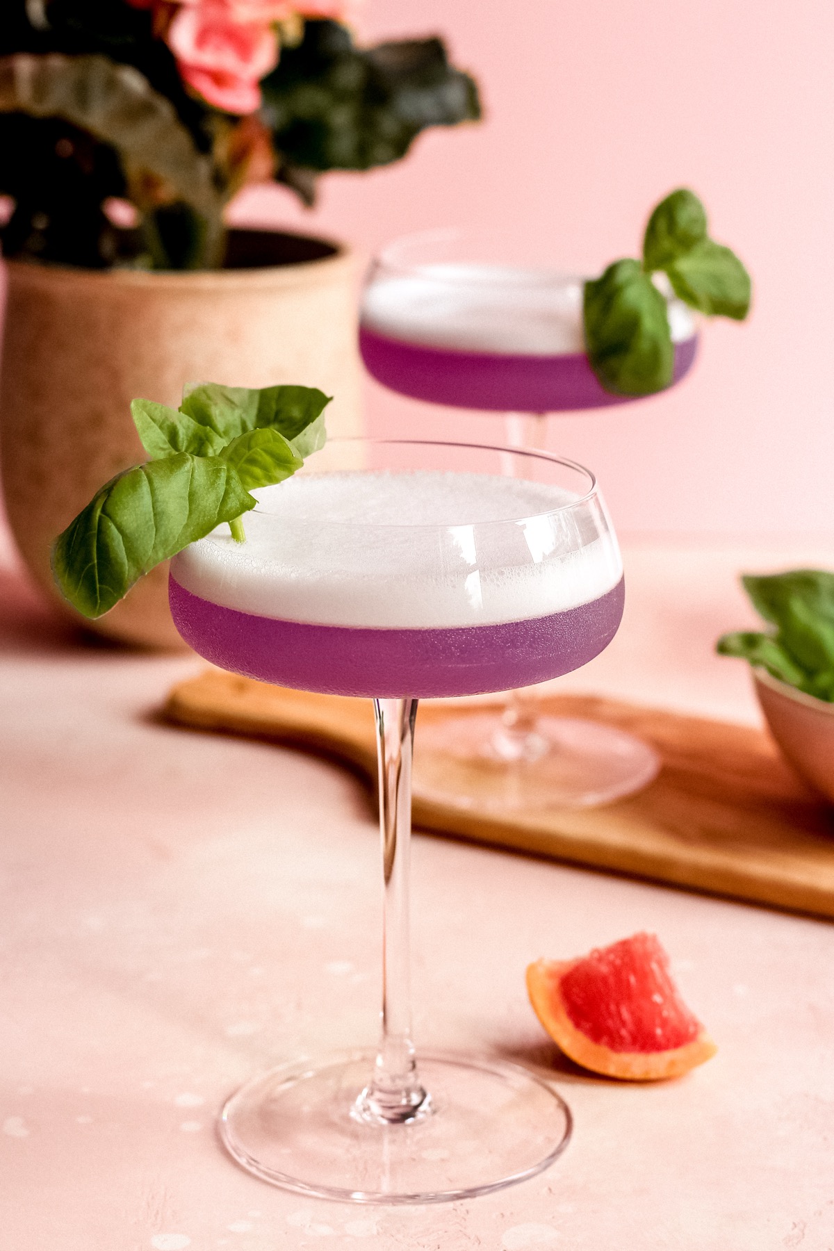 Ruth basil gin-sburg cocktail on a pink backdrop