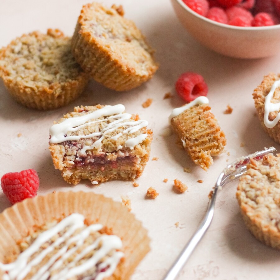 Raspberry cookie cups on a pink backdrop.