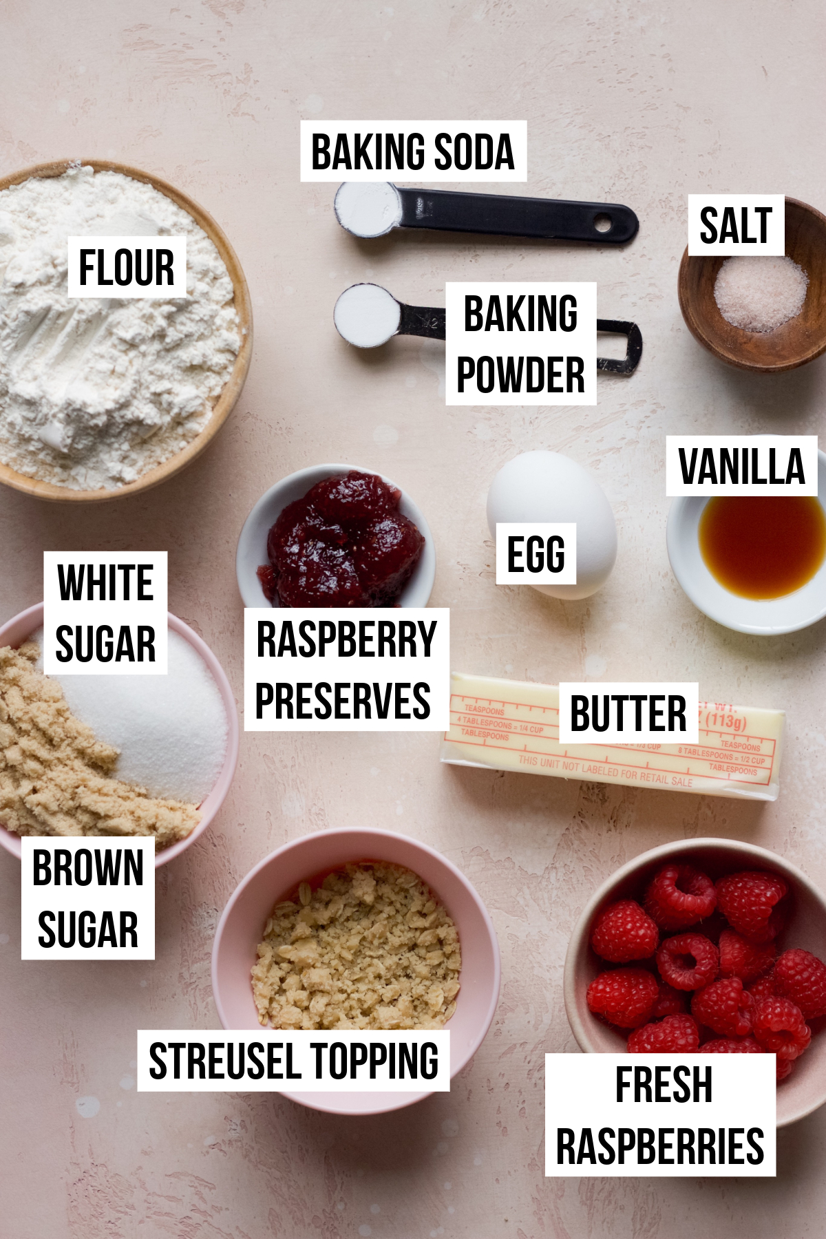 Raspberry muffin cookie ingredients on a pink backdrop