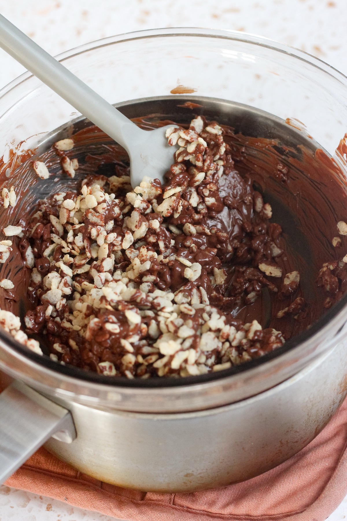Rice Krispies, chocolate chips, and butterscotch chips in a glass bowl.