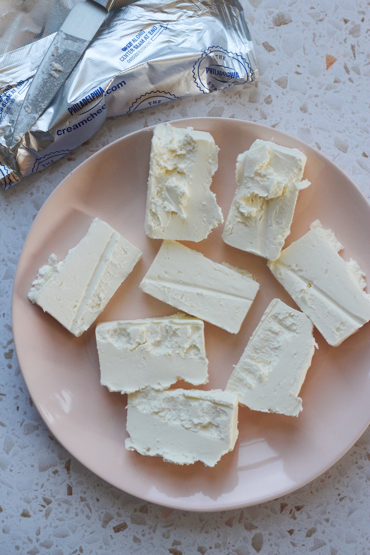 Cream cheese on a pink late.