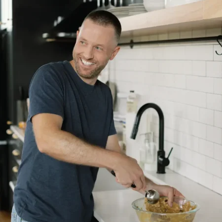 Tyler, author of Schmidty Bakes, cooking in kitchen.