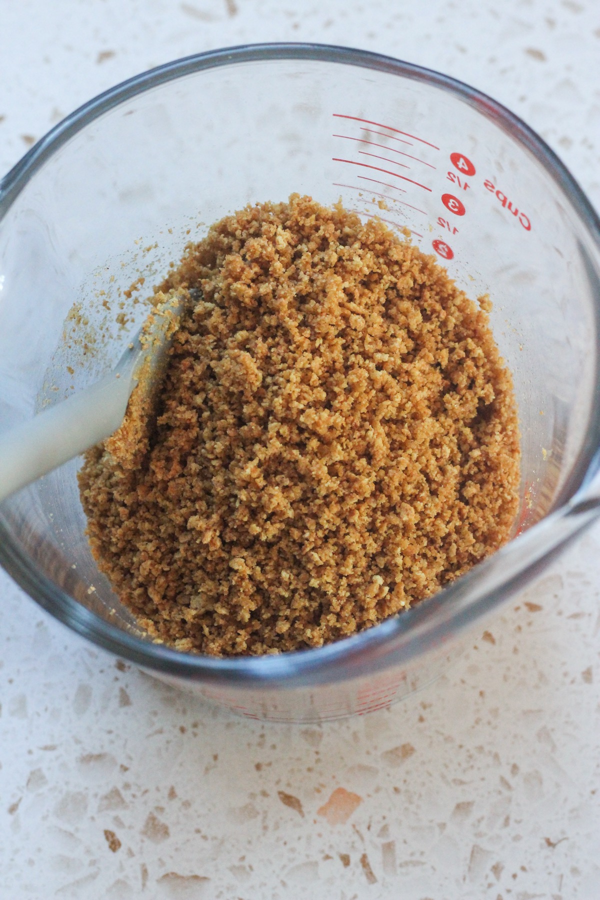 Cinnamon swirl cheesecake graham cracker crust in glass bowl.
