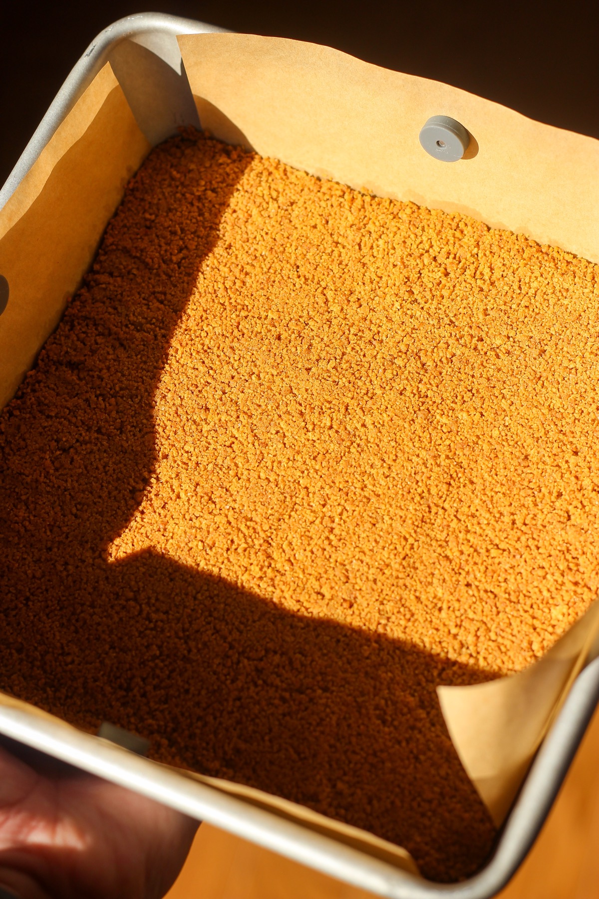 Cinnamon swirl cheesecake crust in baking pan.