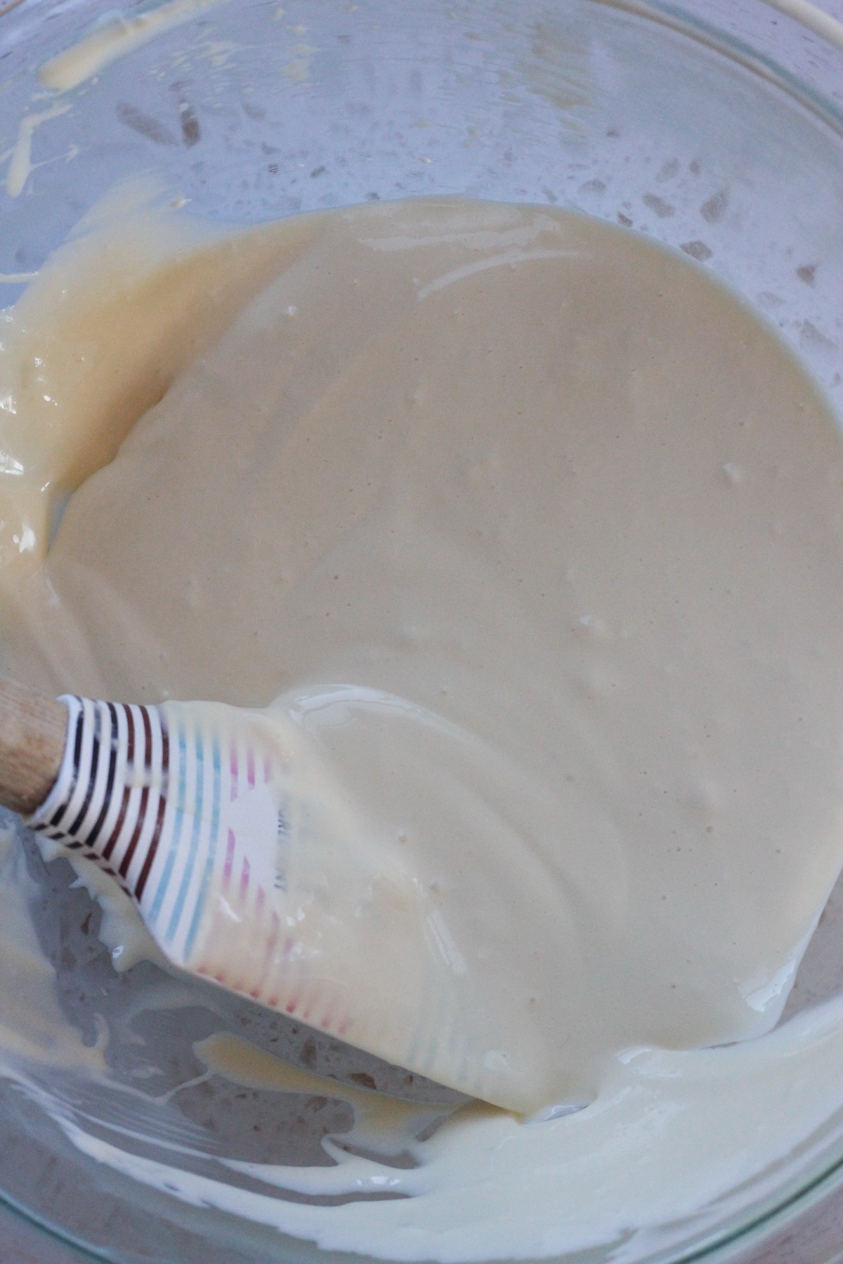 Cinnamon swirl cheesecake batter in a glass bowl.