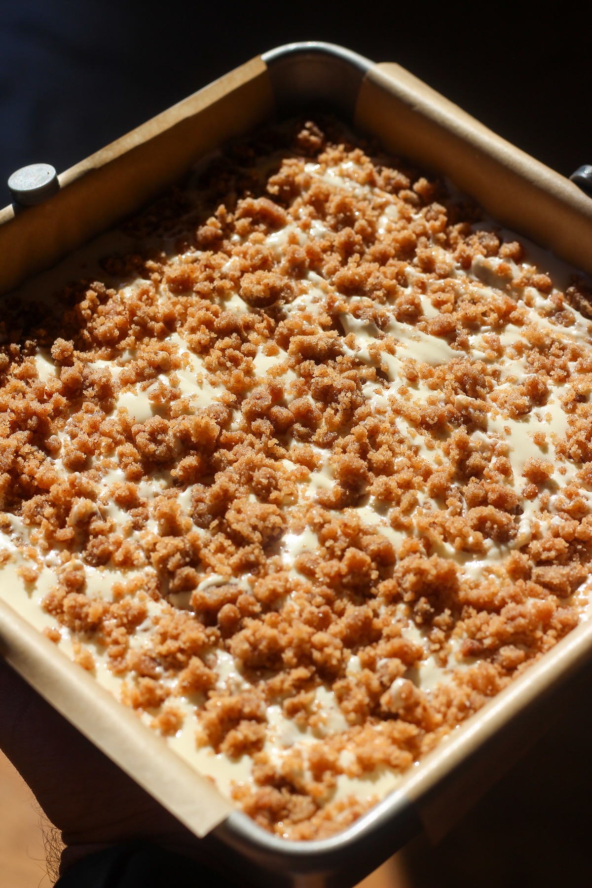 Cinnamon swirl cheesecake bars in a baking sheet.