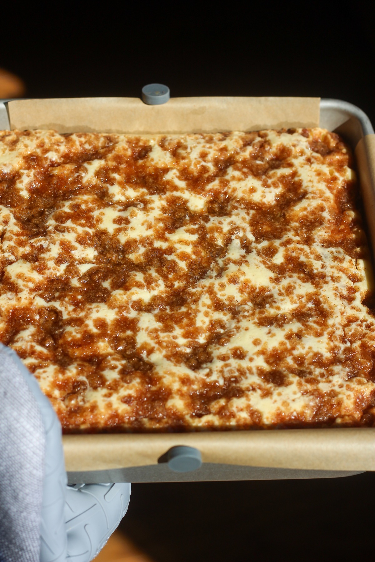 Cinnamon swirl cheesecake bars in a baking pan.
