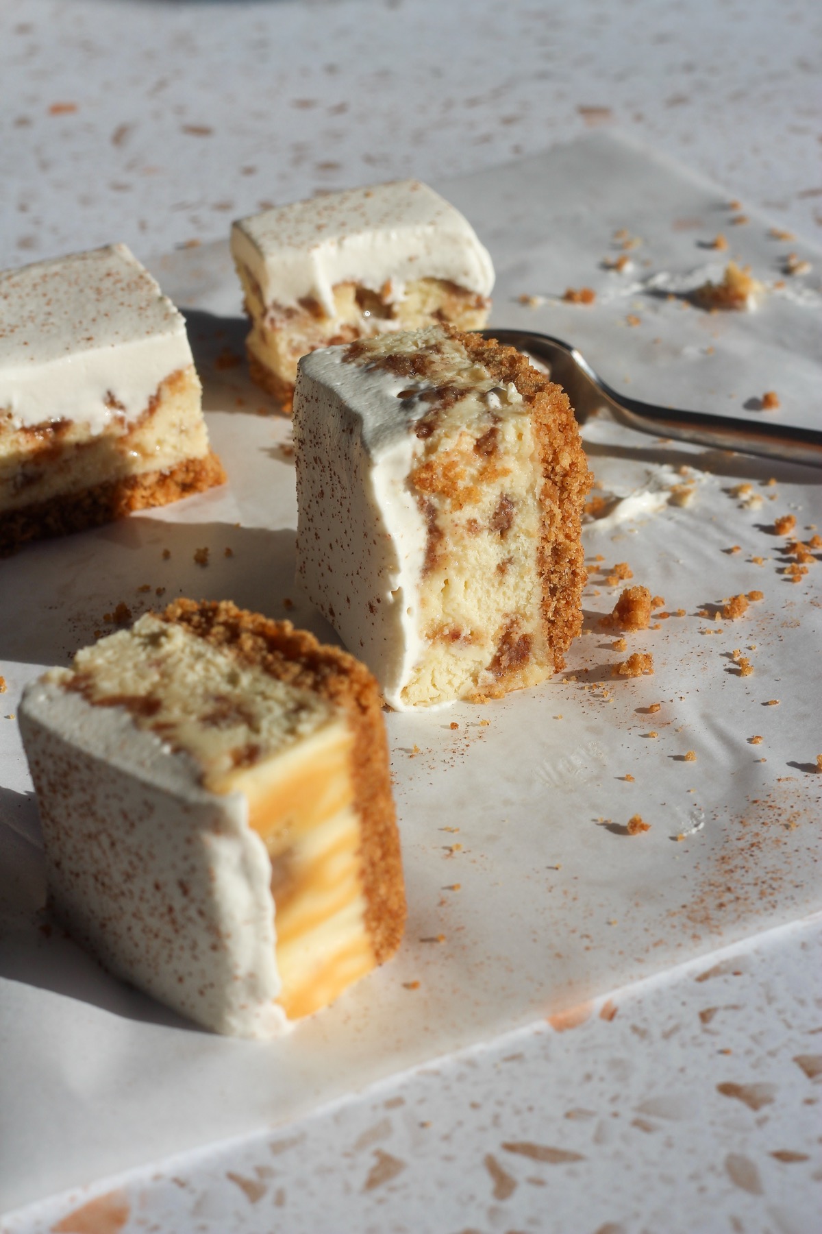 Close up shot of cinnamon swirl cheesecake bars on a backdrop.