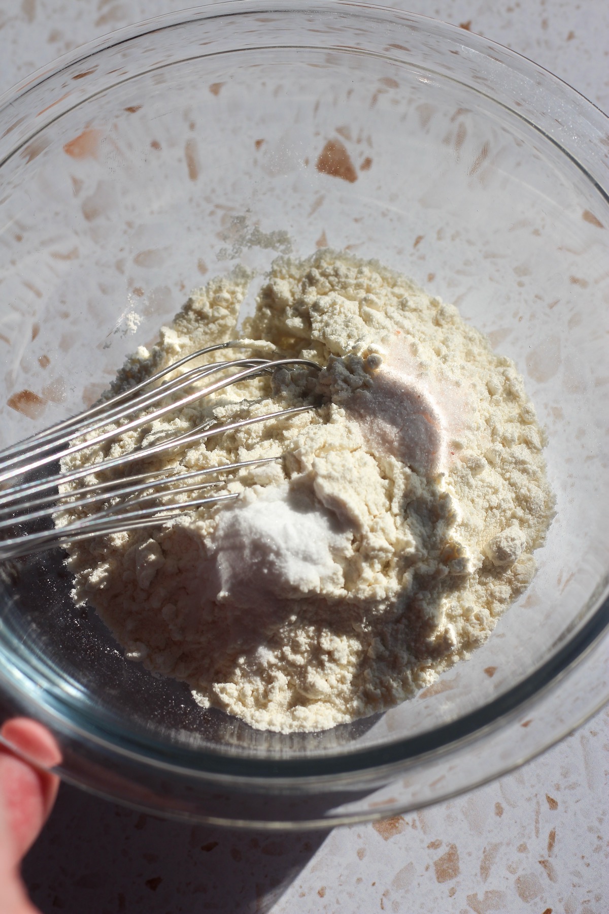 Dry ingredients for Peanut Butter Blossoms in a glass bowl.