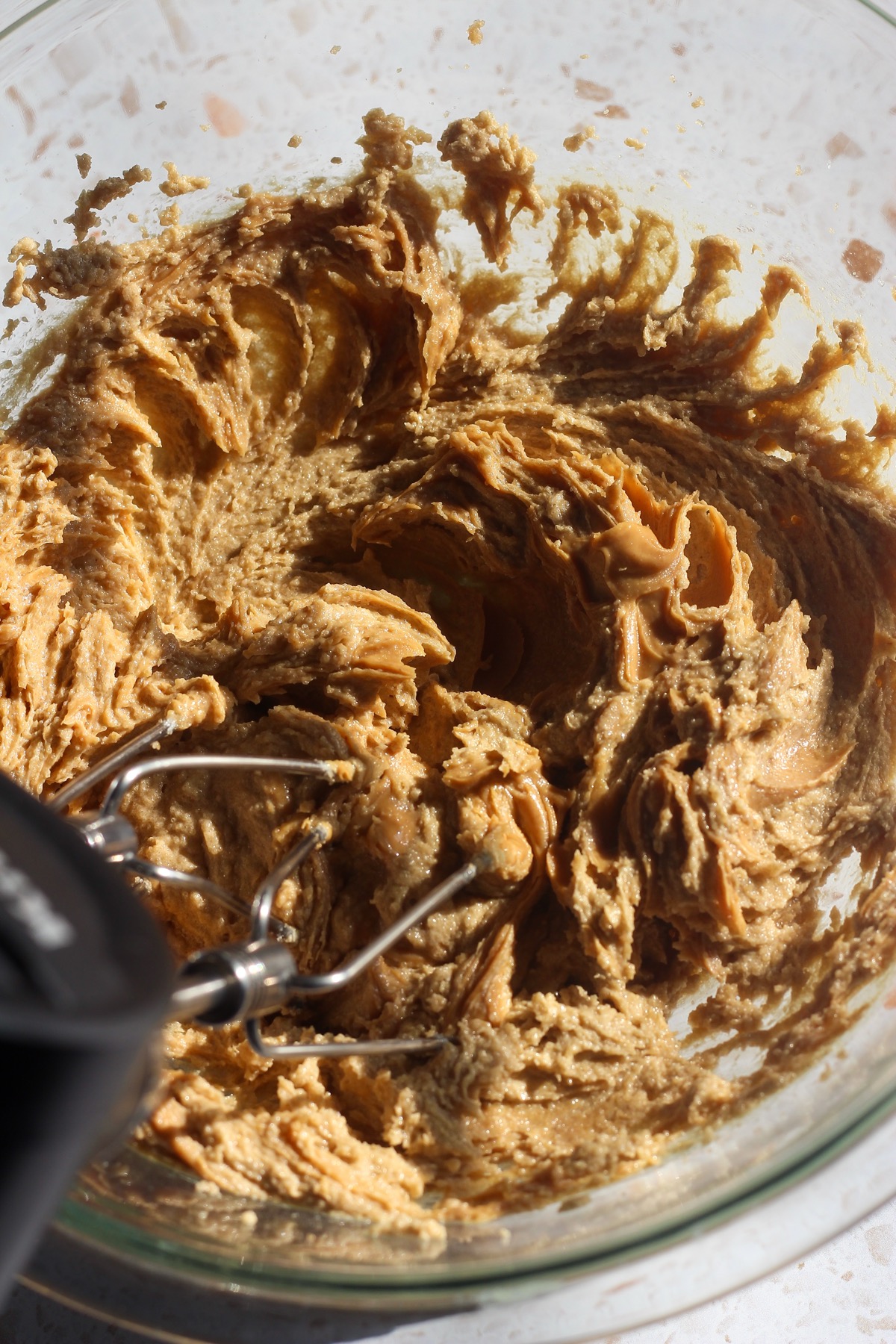 Peanut butter being mixed into the butter and sugar mixture.