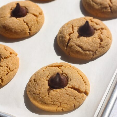 Tray of peanut butter blossoms in direct sunlight.