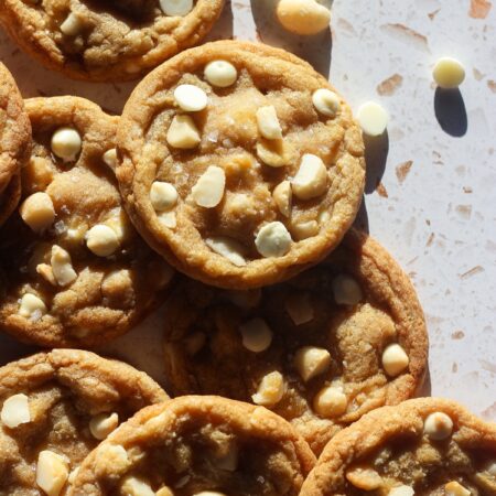 White chocolate macadamia nut cookies in direct sunlight.