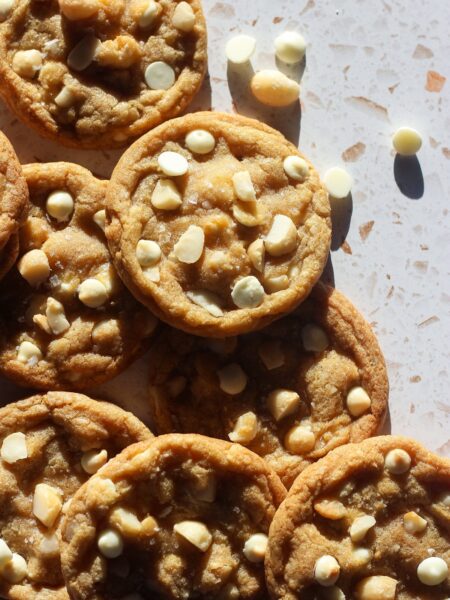 White chocolate macadamia nut cookies in direct sunlight.