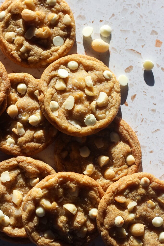White chocolate macadamia nut cookies in direct sunlight.