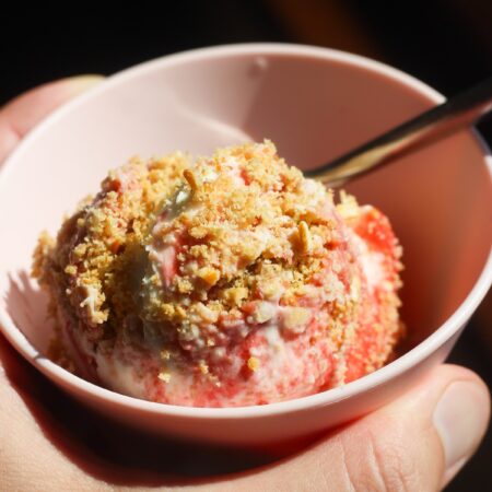 Close up shot of scoopable strawberry cheesecake in a pink bowl