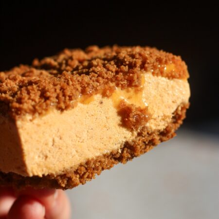 Close-up of a single pumpkin caramel ice cream sandwich with gingersnap crust