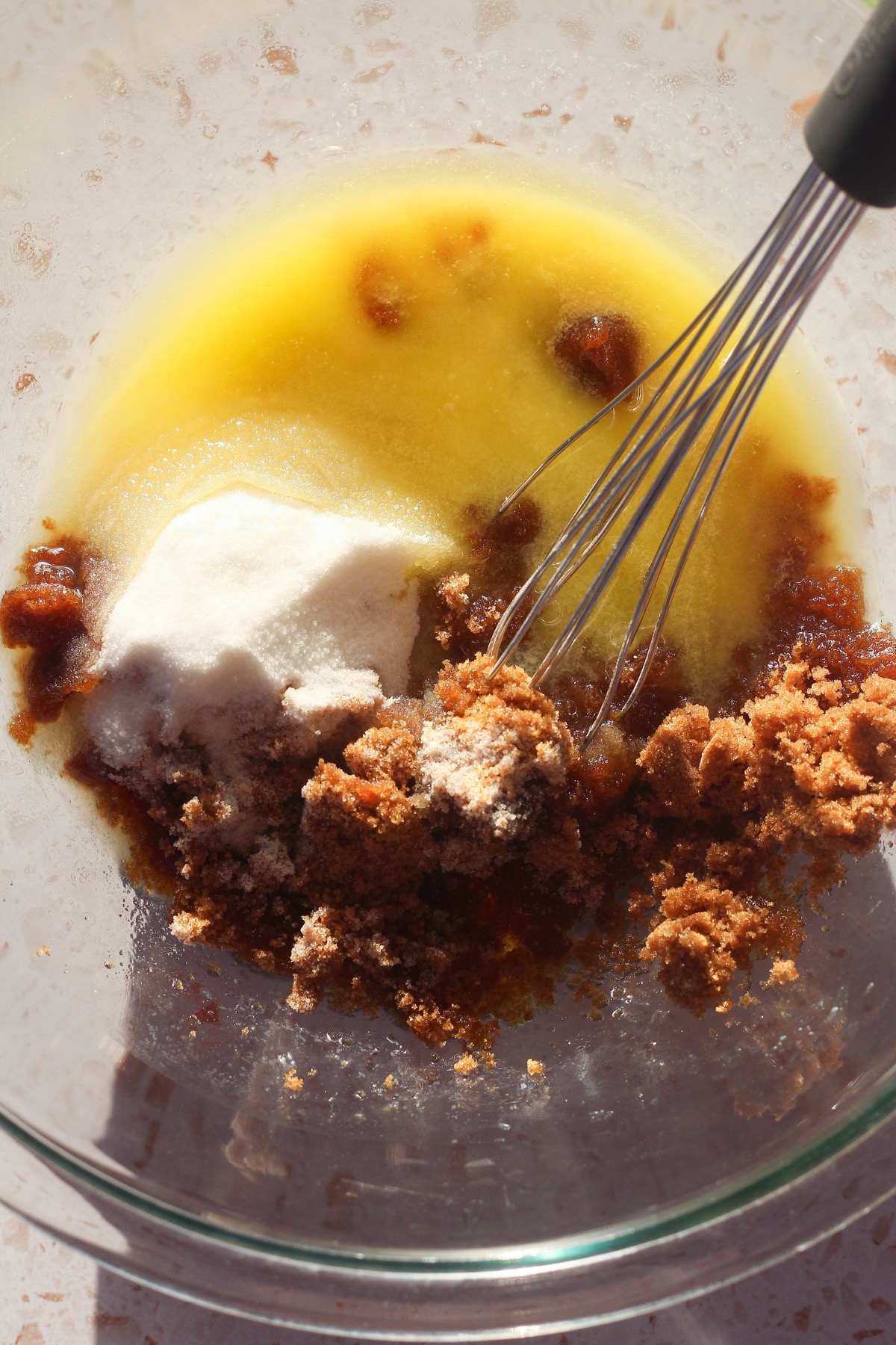 Browned butter, brown sugar, and granulated sugar in a mixing bowl before whisking