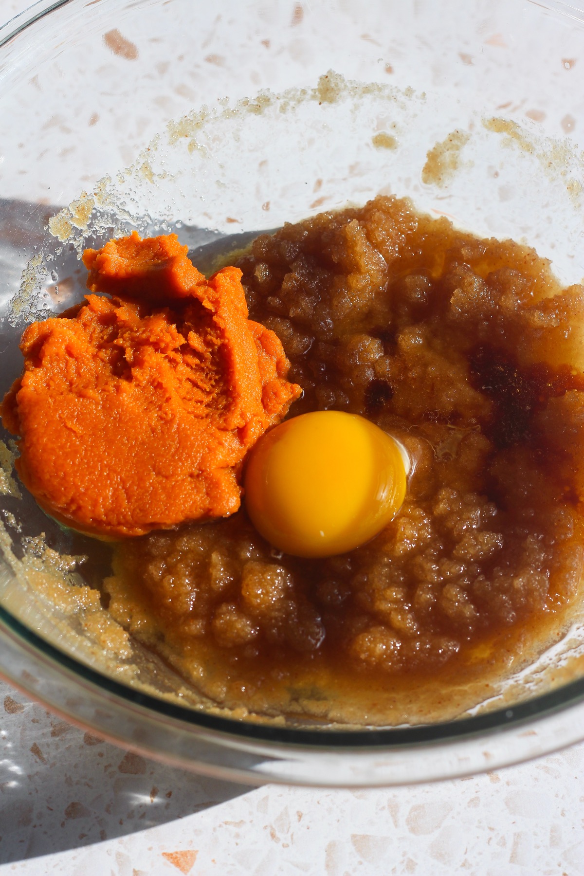 Pumpkin puree and egg added to brown butter and sugar mixture before mixing